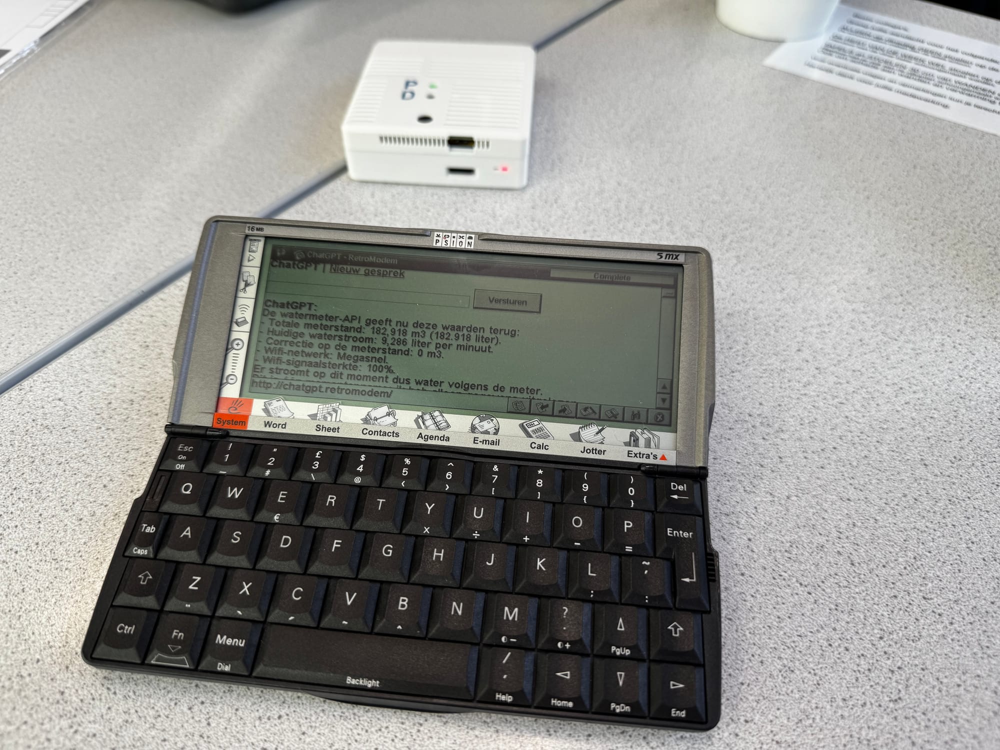 A Psion 5mx using the local ChatGPT web app with RetroModem in the background